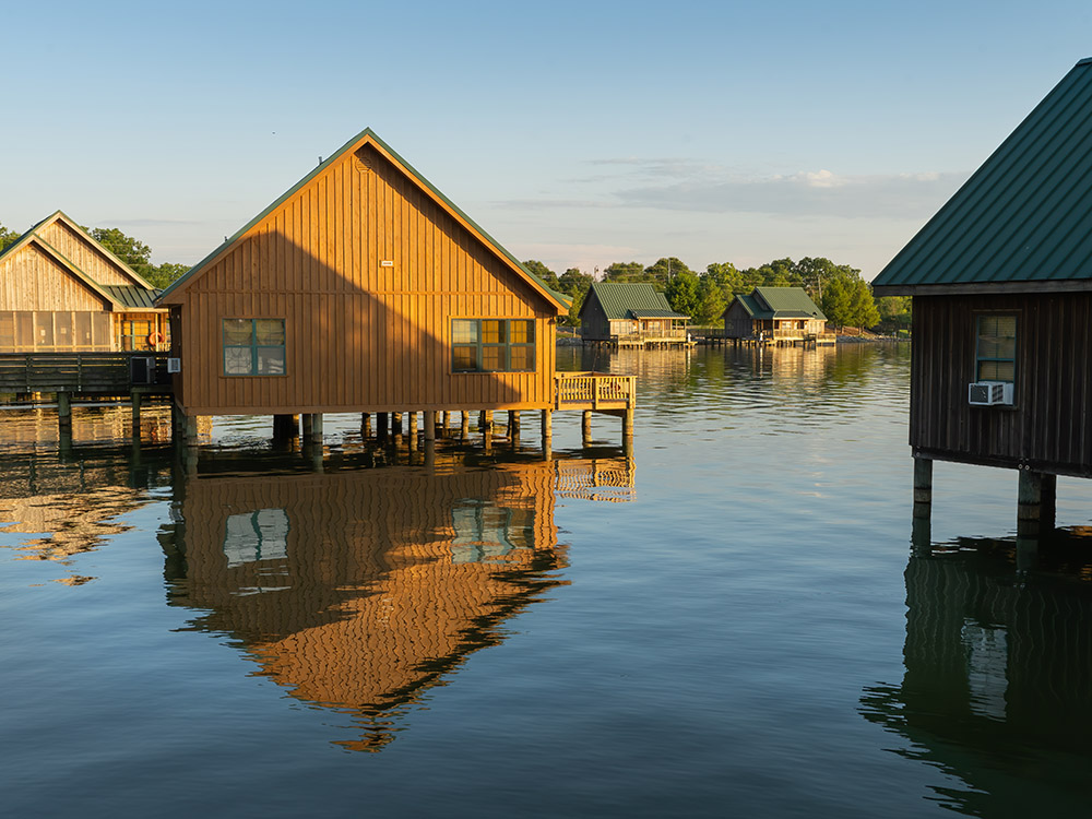 vacation cabins sit on pilings above lake at Poverty Point Reservoir State Park