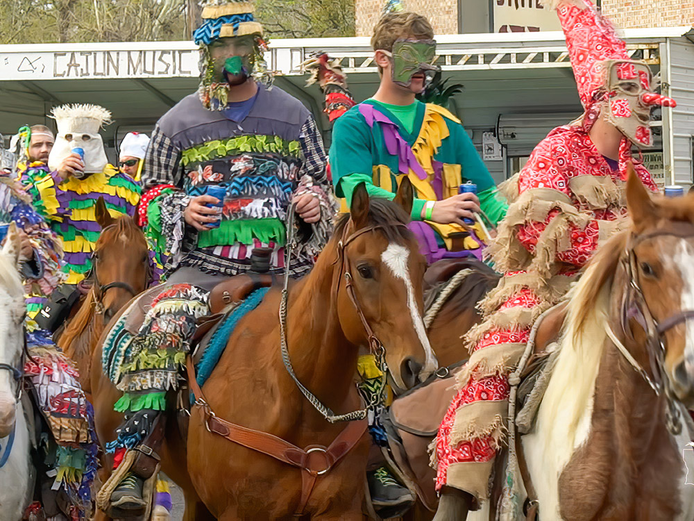 Mardi Gras riders on horseback in masks and colorful costumes in Mamou