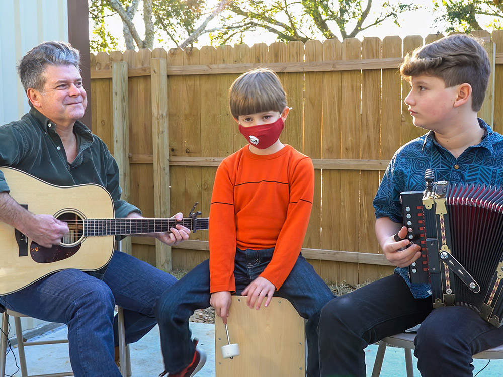 playing Cajun music with Steve Riley plays guitar, son Dolsy plays drum and son Burke plays accordion