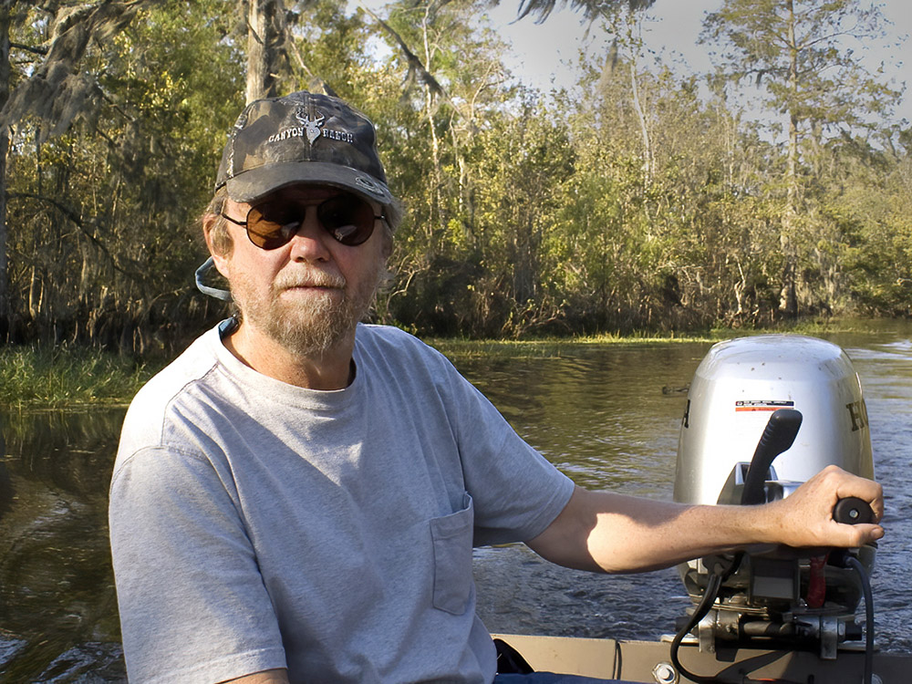 nature photographer C. C. Lockwood operating his boat in the Louisiana swamp
