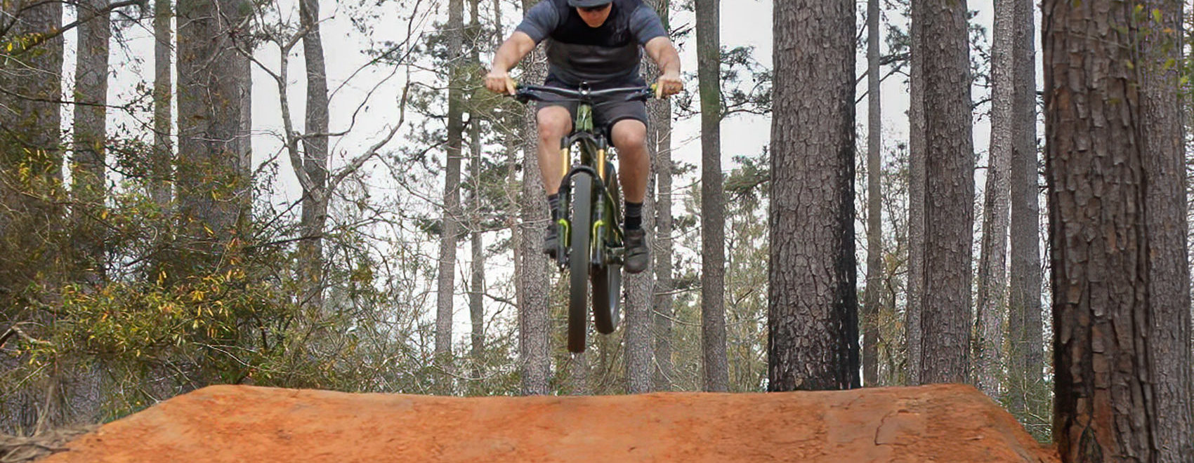 mountain bike jumps hill on bike trail in Bogue Chitto State Park Louisiana