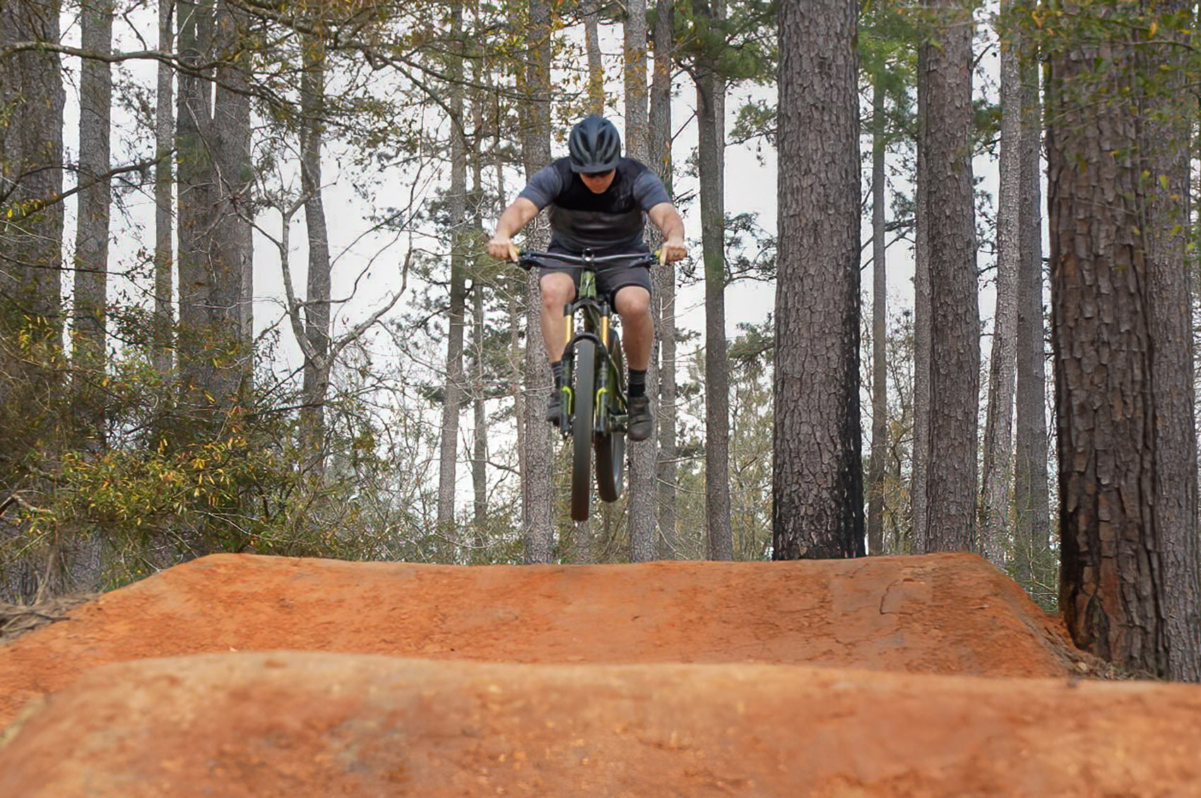 mountain bike jumps hill on bike trail in Bogue Chitto State Park Louisiana