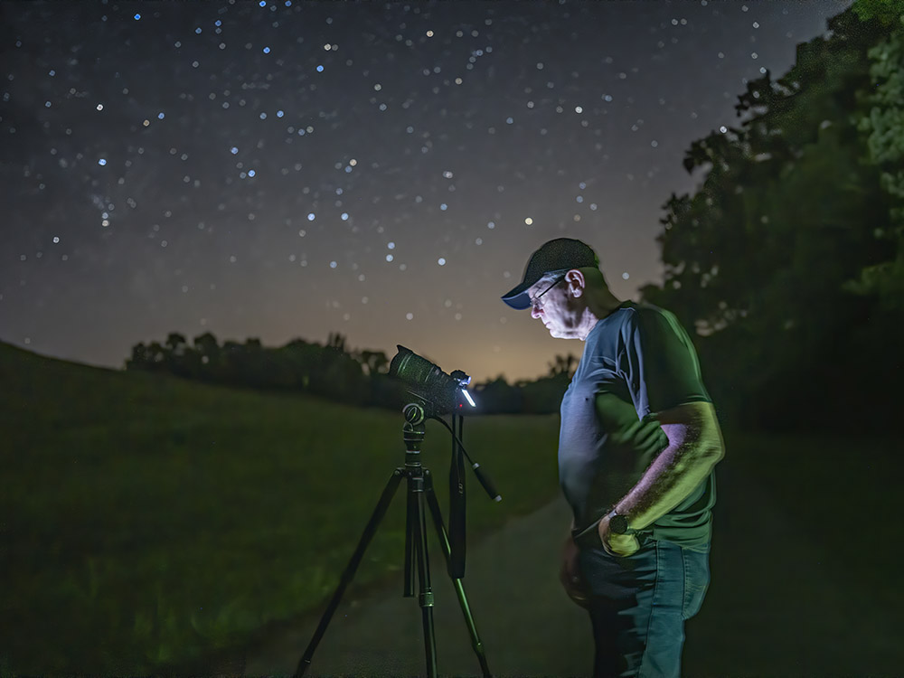 man taking star pictures at mound at Poverty Point Louisiana