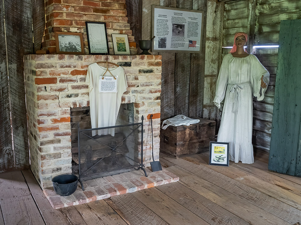 clothing and quotes from slave narratives on display in slave cabin at Frogmore Plantation Louisiana