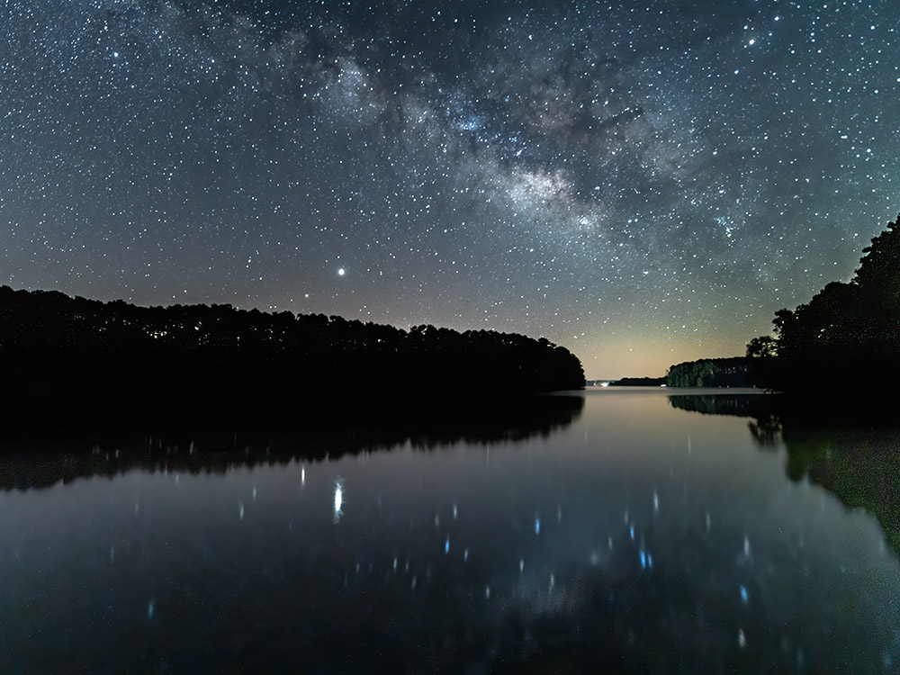 milky way reflected in still water of lake at North Toledo Bend State Park