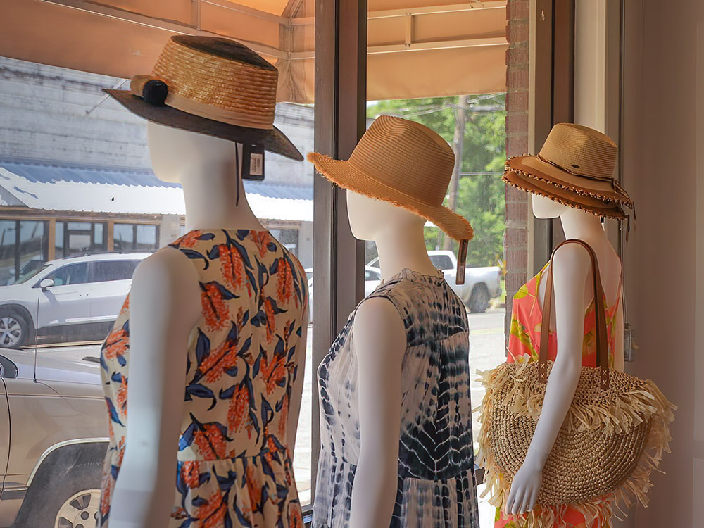 women dresses and hats on display in store window in Saint Joseph Louisiana