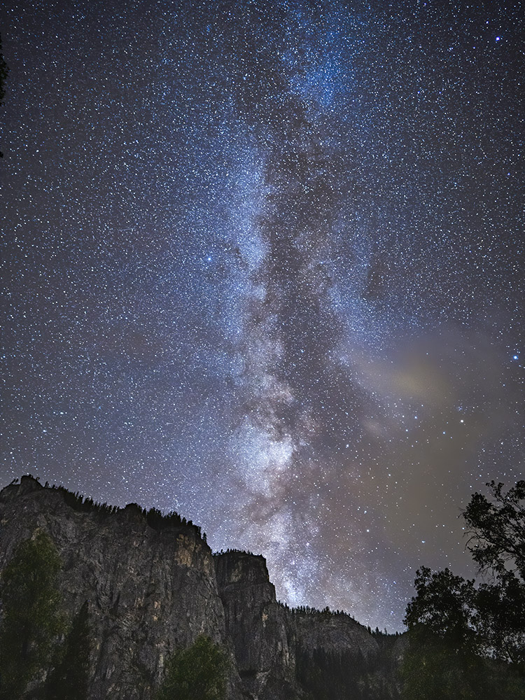 Milky Way rises above granite cliffs in Yosemite National Park California