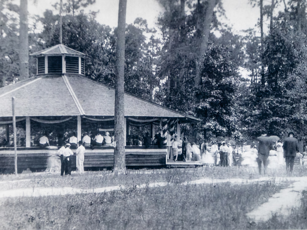 black and white photograph of people at outdoor dance pavilion