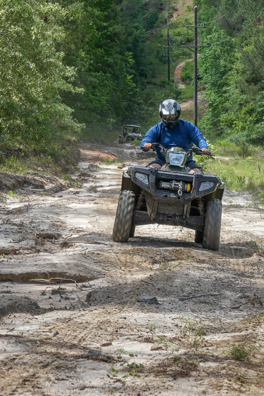 ATV rider coming toward camera on dirt trail in the wood south toledo bend state park