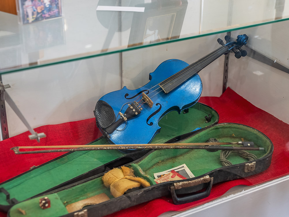 blue fiddle in case at Cajun music museum display