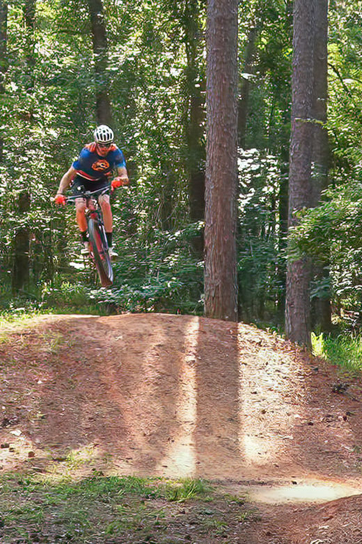 Mountain biker gets air on trail jump
