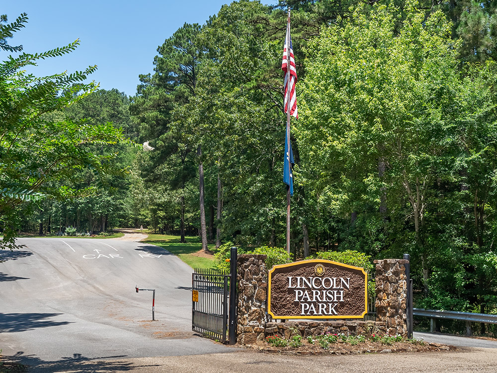 entrance with U.S. flag and sign at Lincoln Parish Park