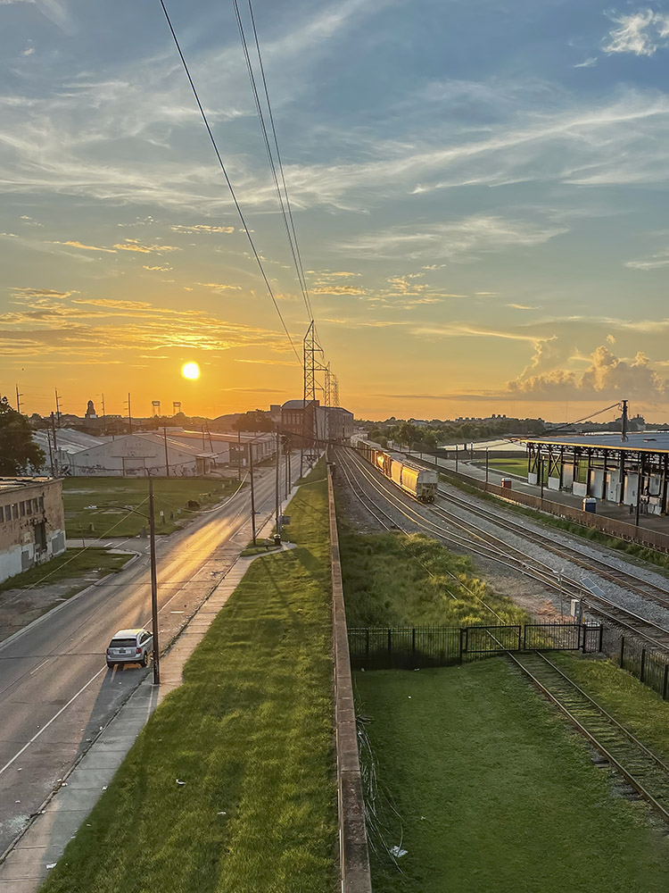 view above riverfront railroad tracks at sunrise in New Orleans