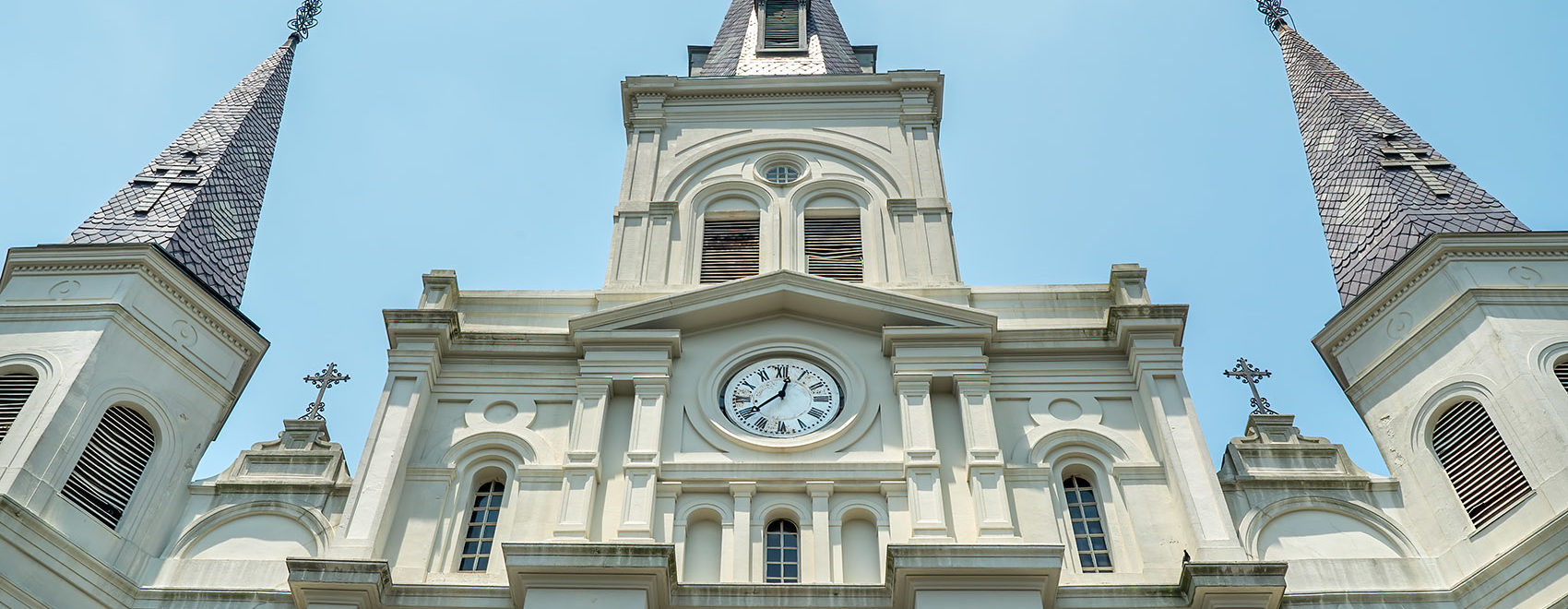 front of large church steeple clock light gray color saint louis cathedral new orleans