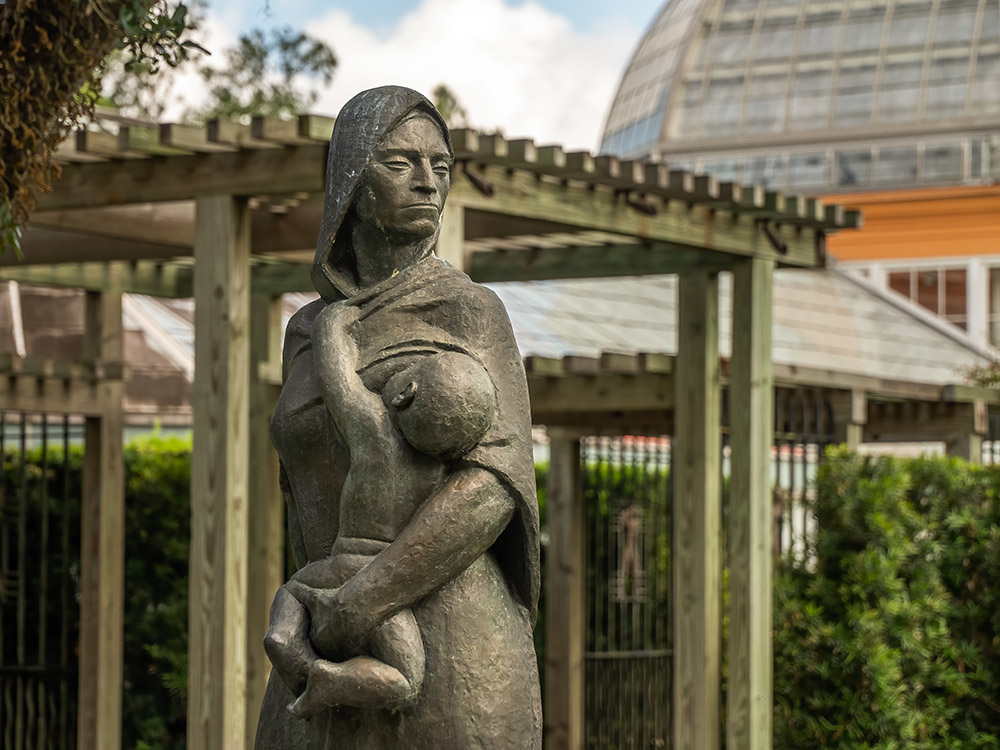 statue of woman breastfeeding in sculpture garden new orleans