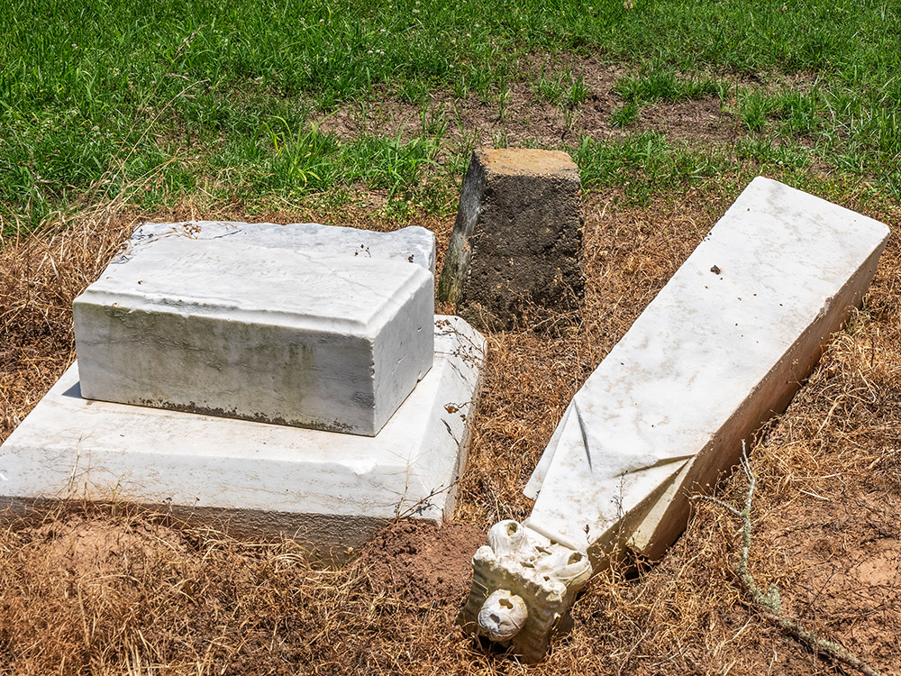 pieces of grave monuments on the ground