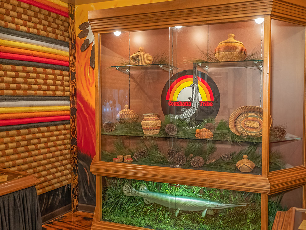 native american museum display with tribal seal and baskets of Coushatta