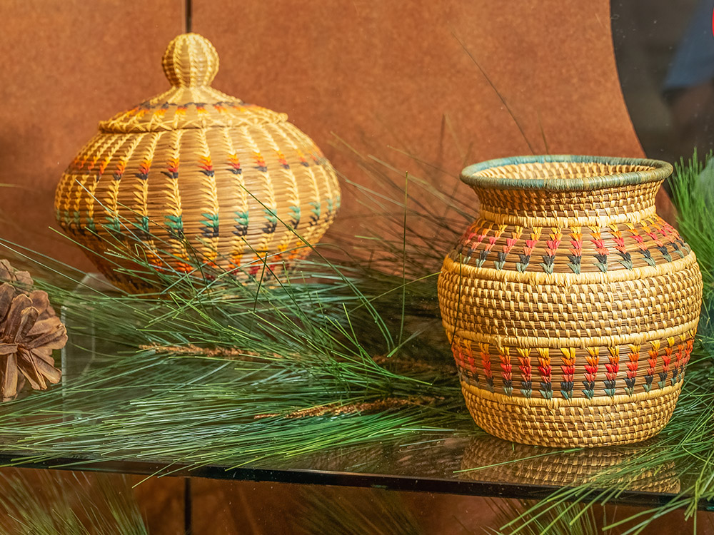 two native american baskets woven from longleaf pine straw