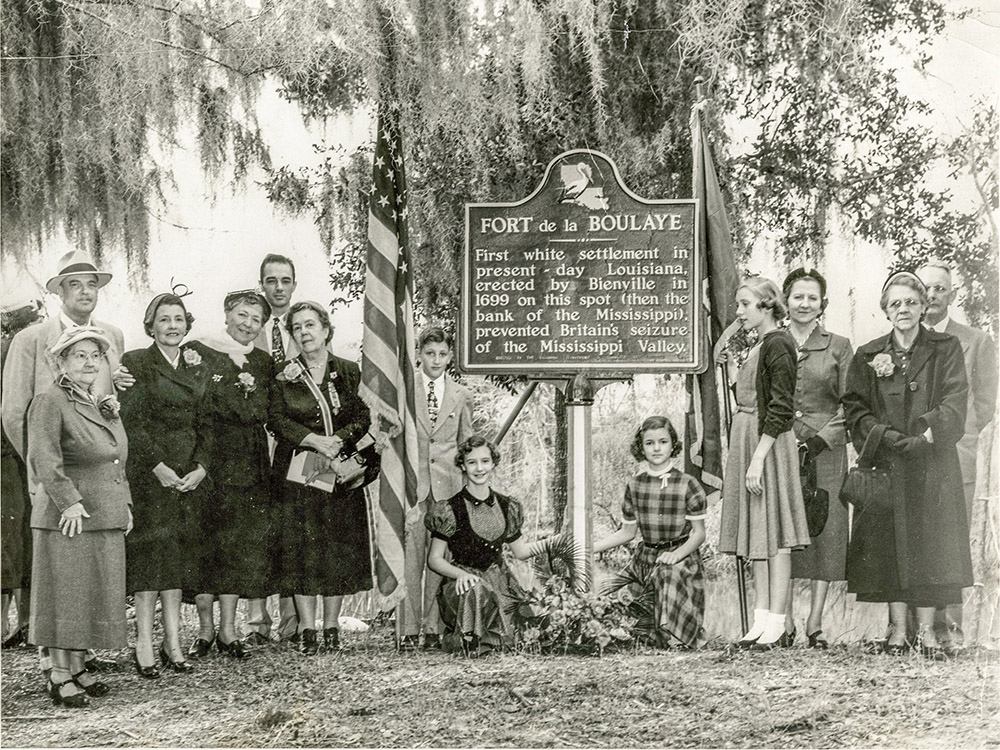 people pose for pictures with historical marker for Louisiana fort