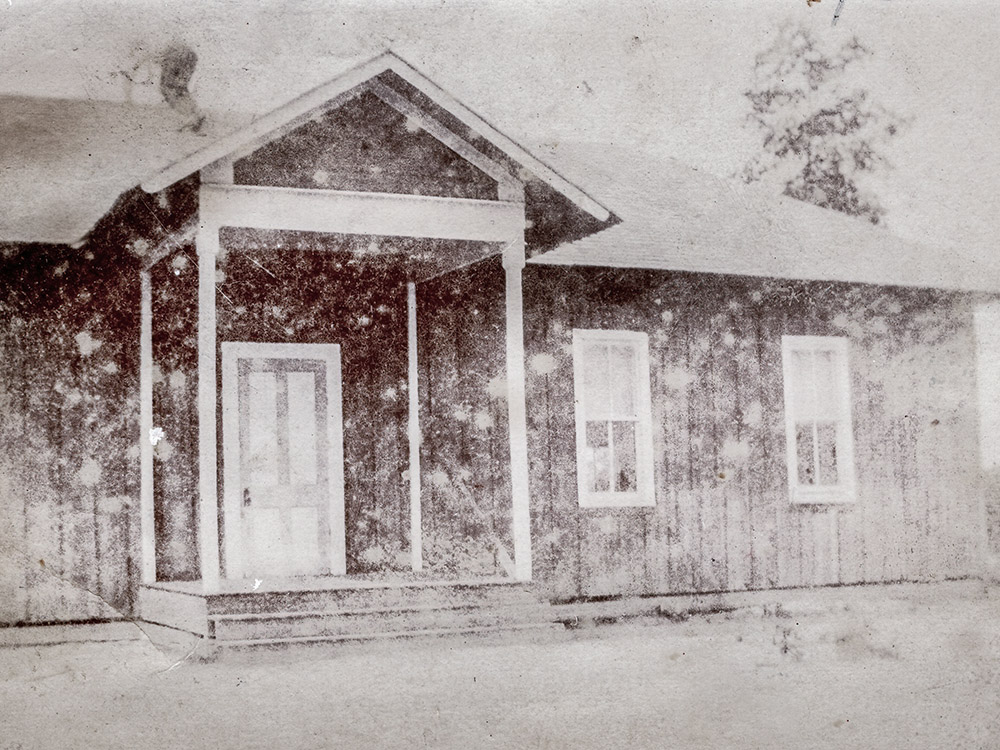 old black and white photo of wood school house in Husser