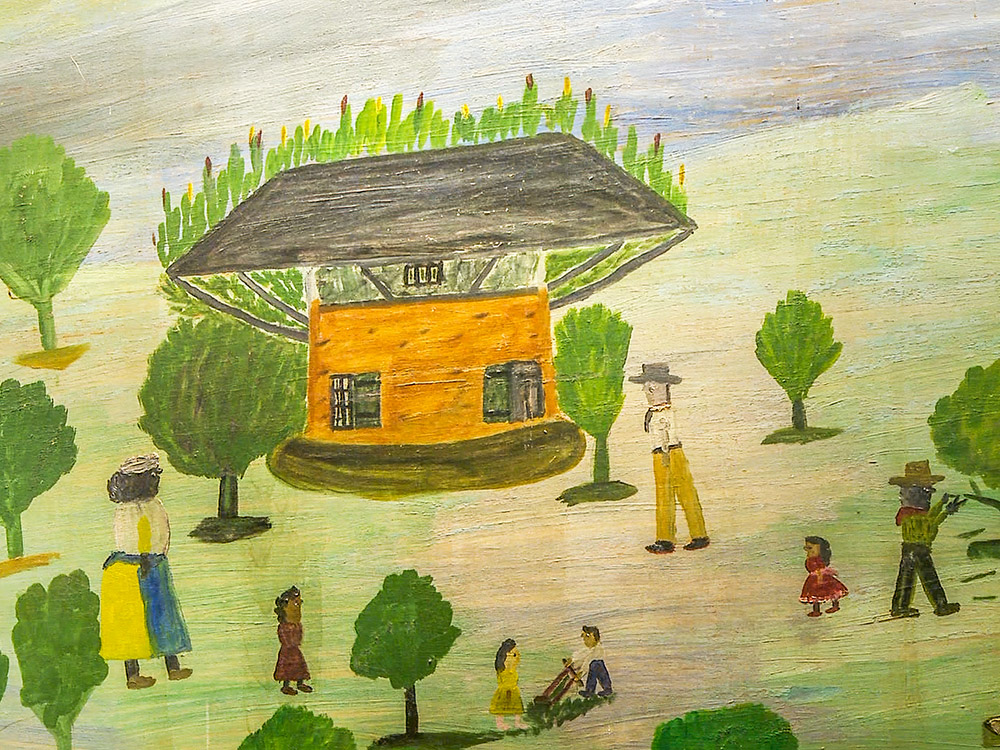 Clementine Hunter folk painting of old house and people and trees