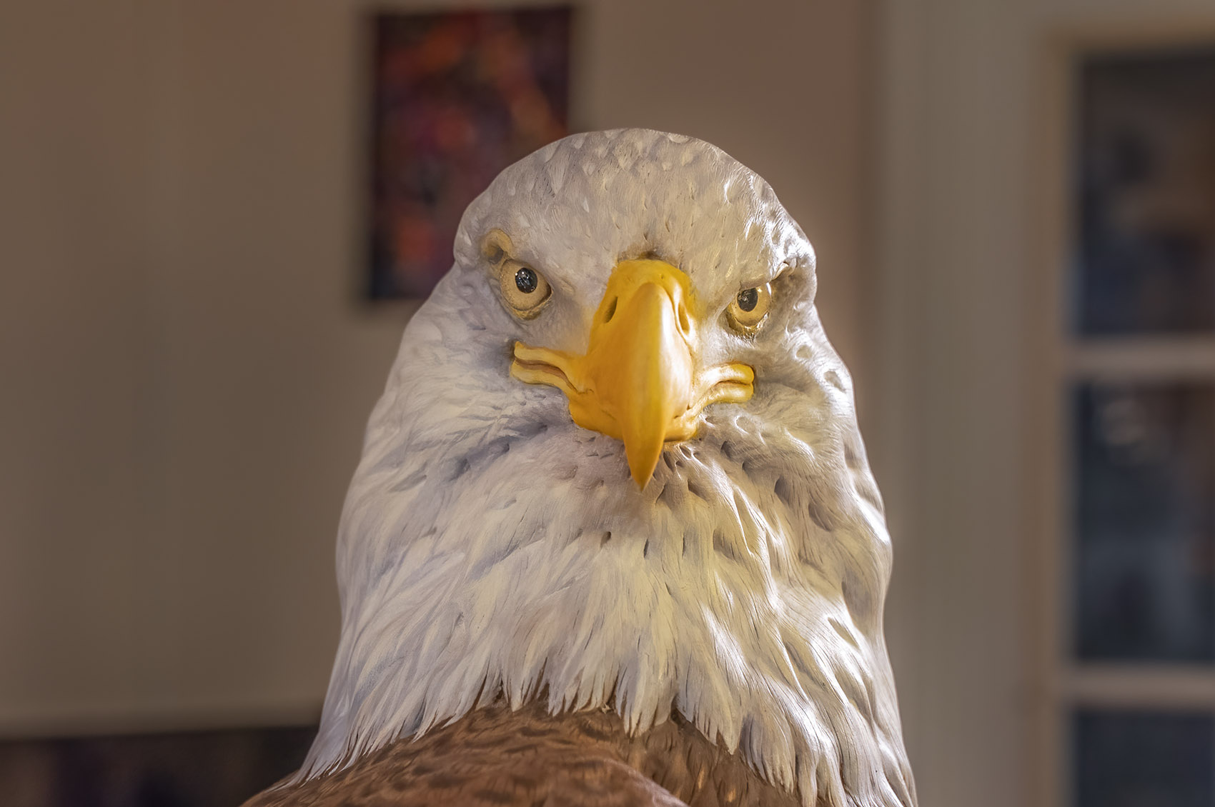 closeup of bald eagle head carved from wood