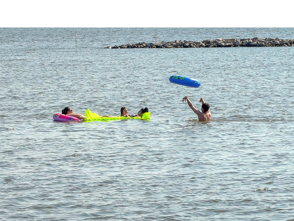 children with inflatables play in water at Cypremort Point