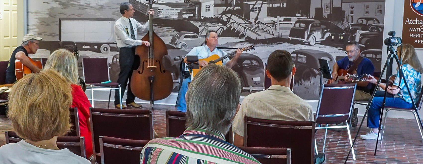 musicians playing acoustic instruments to small audience at west baton rouge museum