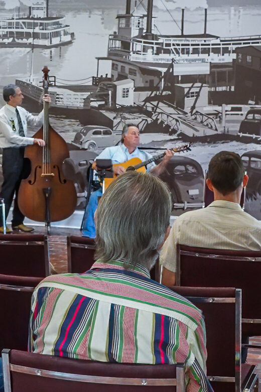 musicians playing acoustic instruments to small audience at west baton rouge museum