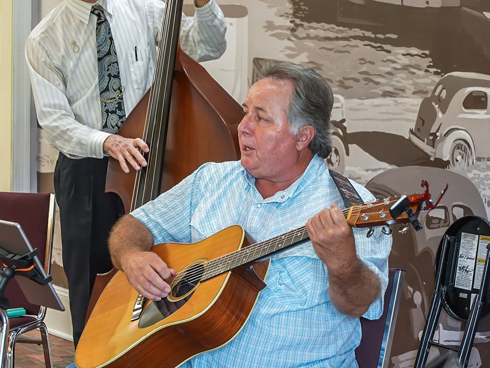 man playing guitar and singing and other man playing upright bass on jam session