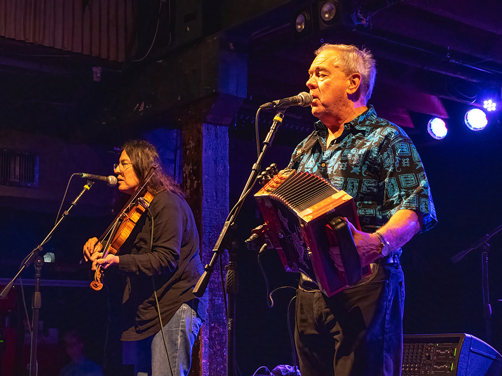 Bruce Daigrepont on accordion sings next to woman playing fiddle at Tipitina's Fais-dodo