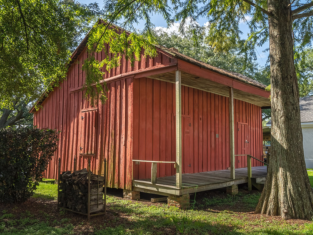 Red wooden slave cabin at West Baton Rouge Museum