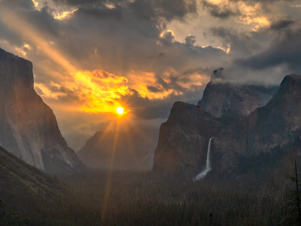 morning sunrise and sunrays at Yosemite with waterfall