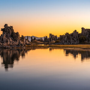 dawn colors of blue and orange reflection limestone formations at Mono Lake