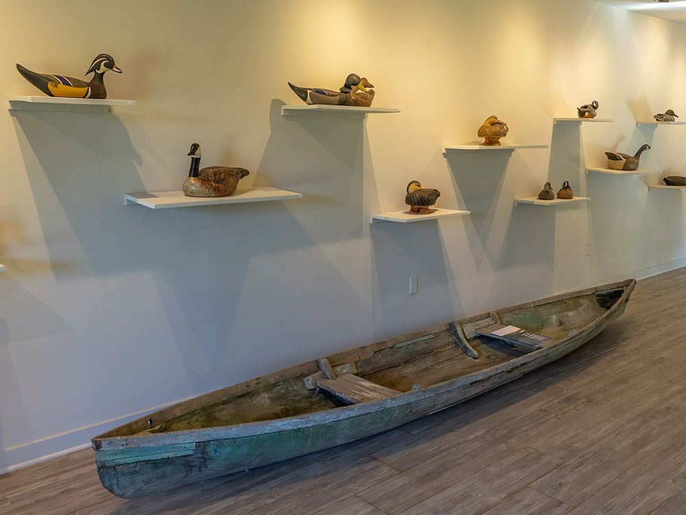 wood duck decoy art and small boat part of river house display