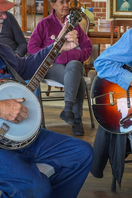man playing banjo and man playing guitar at bluegrass jam