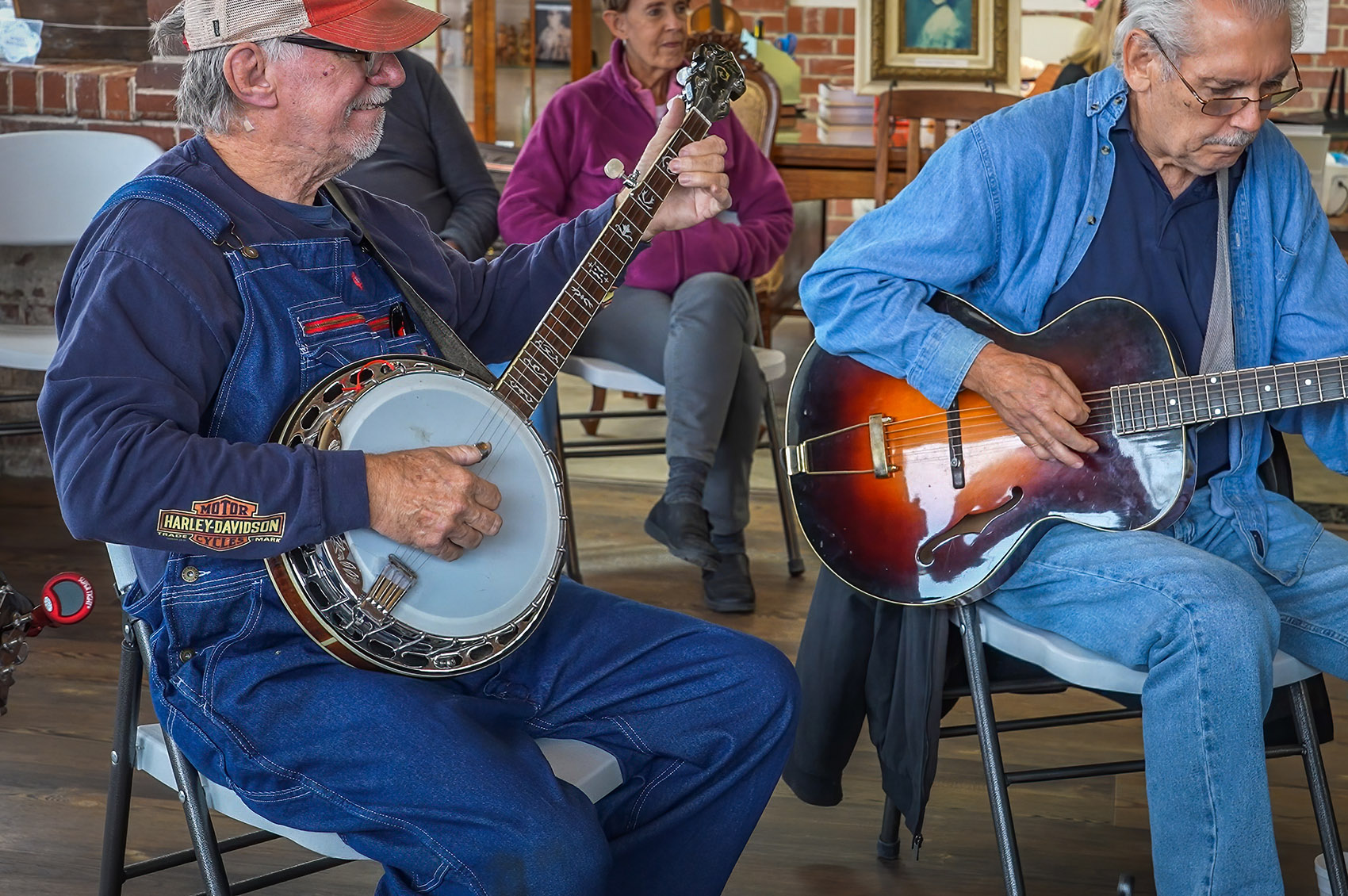 man playing banjo and man playing guitar at bluegrass jam