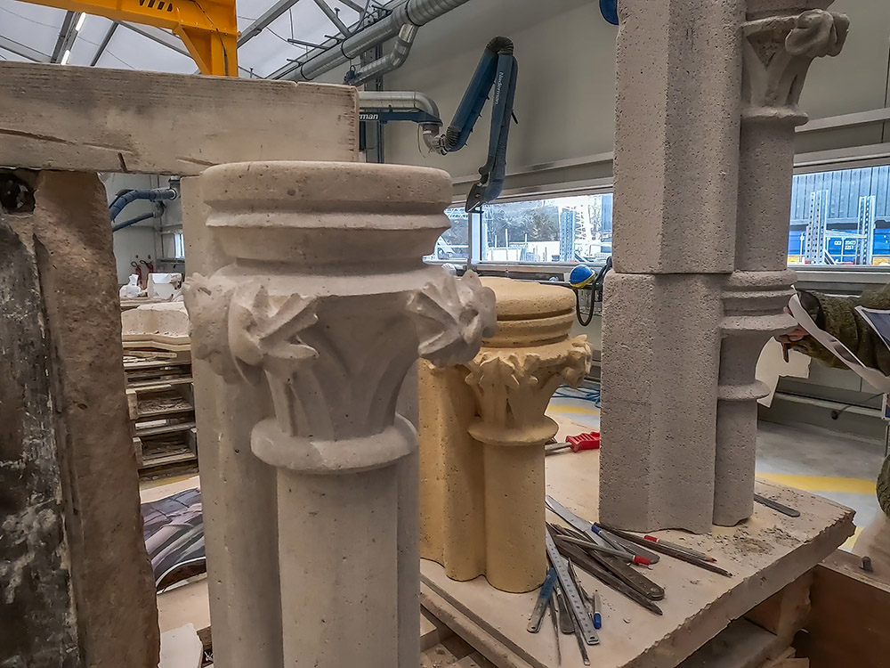 ornamental stonework being copied on workbench with tools