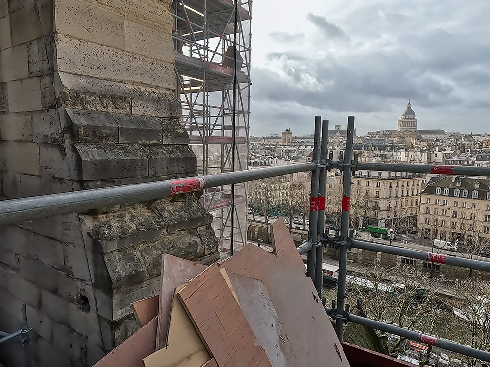 view of Paris skyline from roof and scaffolding at Notre Dame