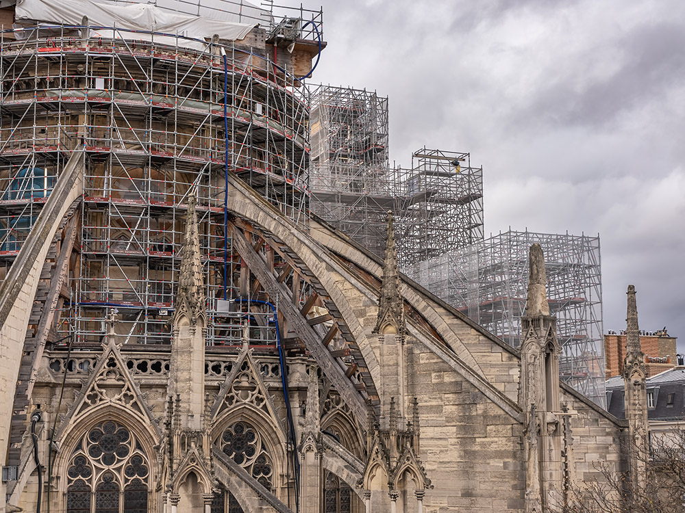 rooftop view of stone flying buttresses and scaffolding outside Notre Dame