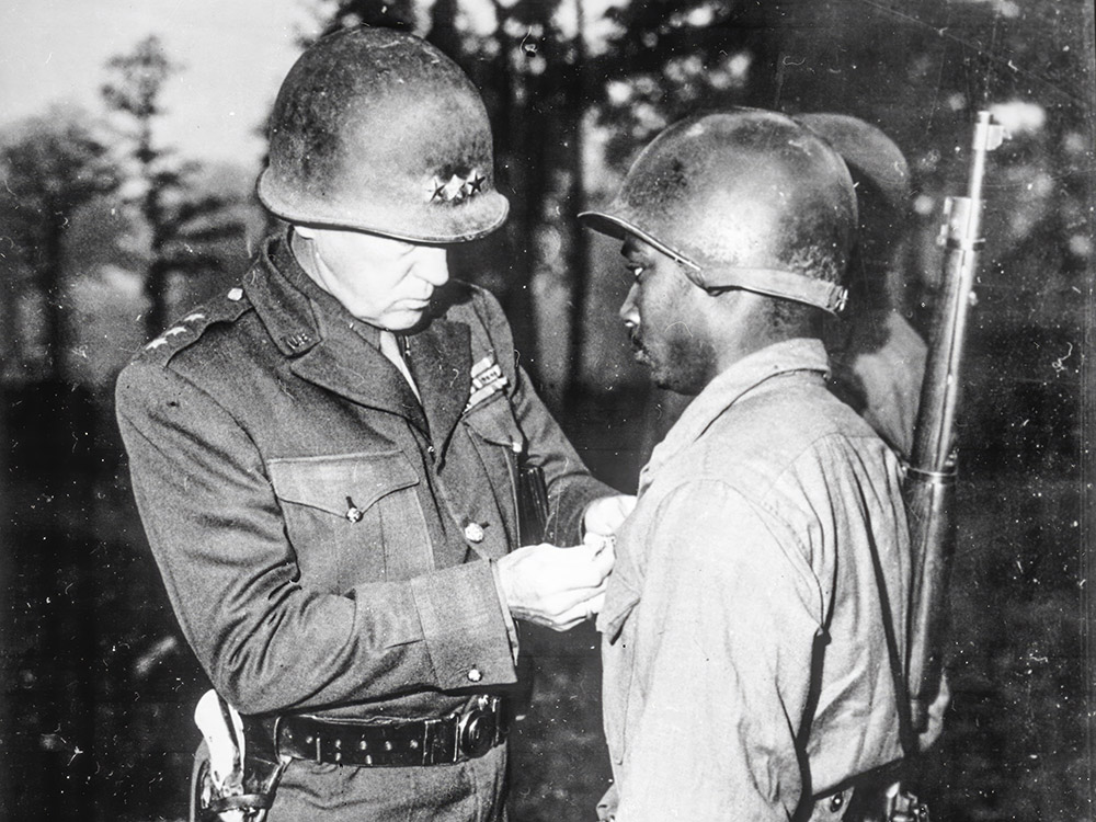 General Patton pins medal on Black soldier 