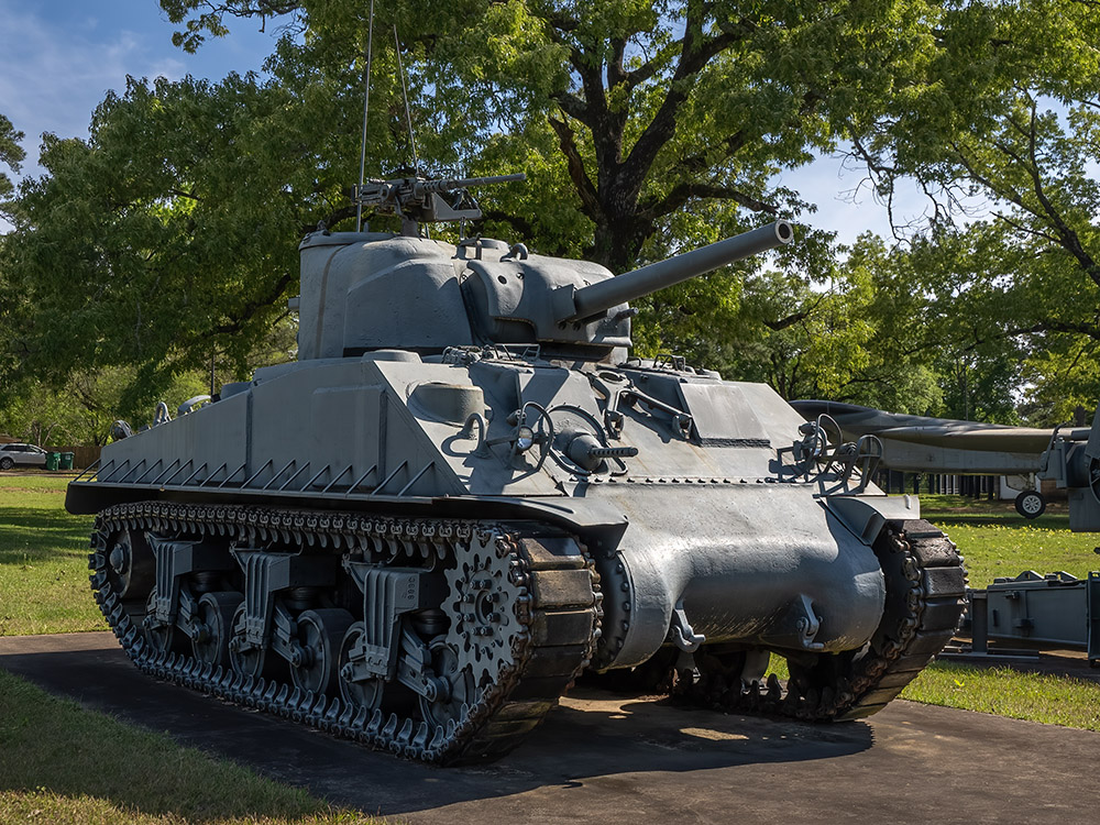 Sherman tank on display near trees