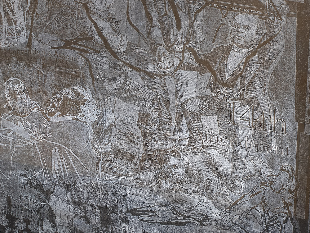 etching in brown granite depicts historical drawing