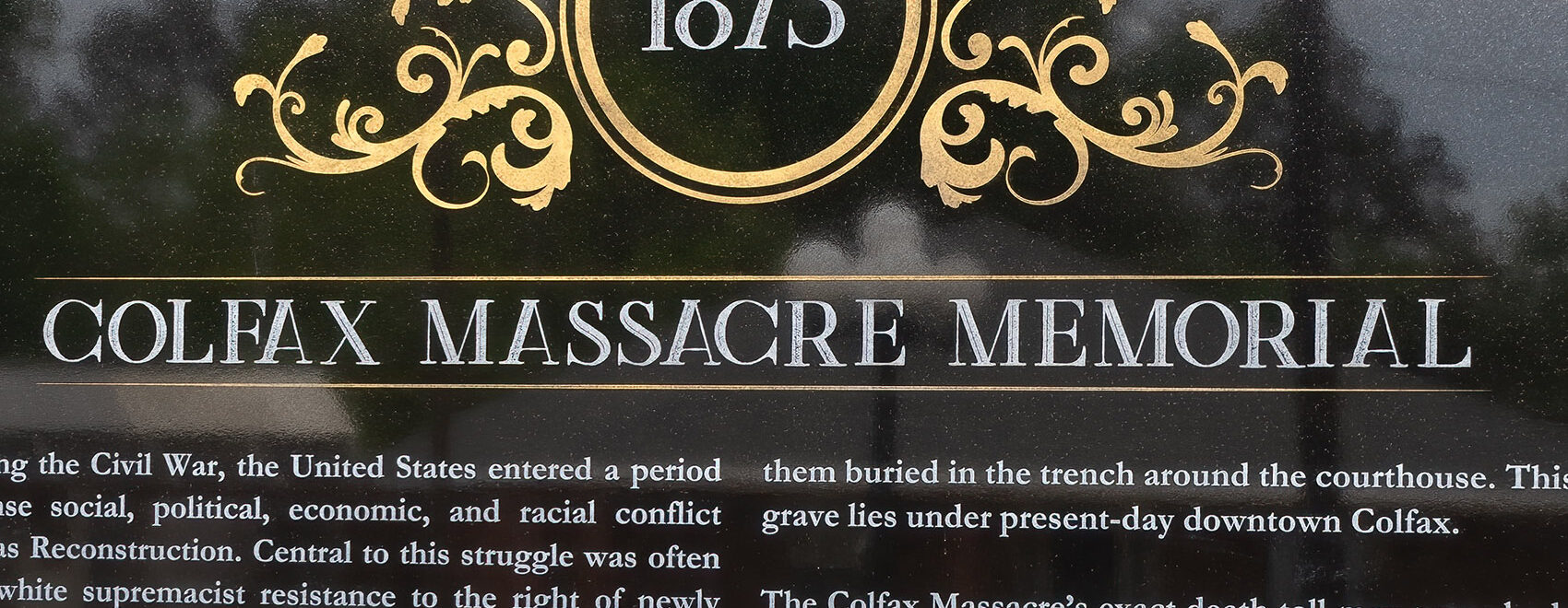 dark granite memorial with date 1873 and colfax massacre