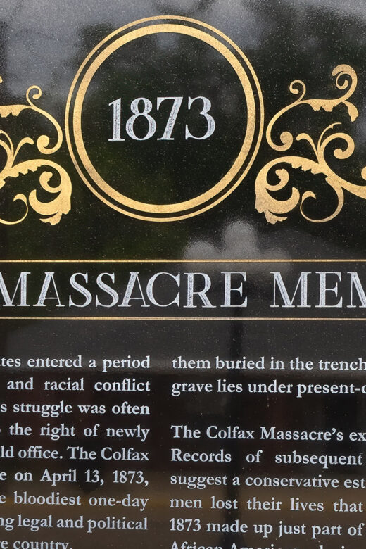 dark granite memorial with date 1873 and colfax massacre