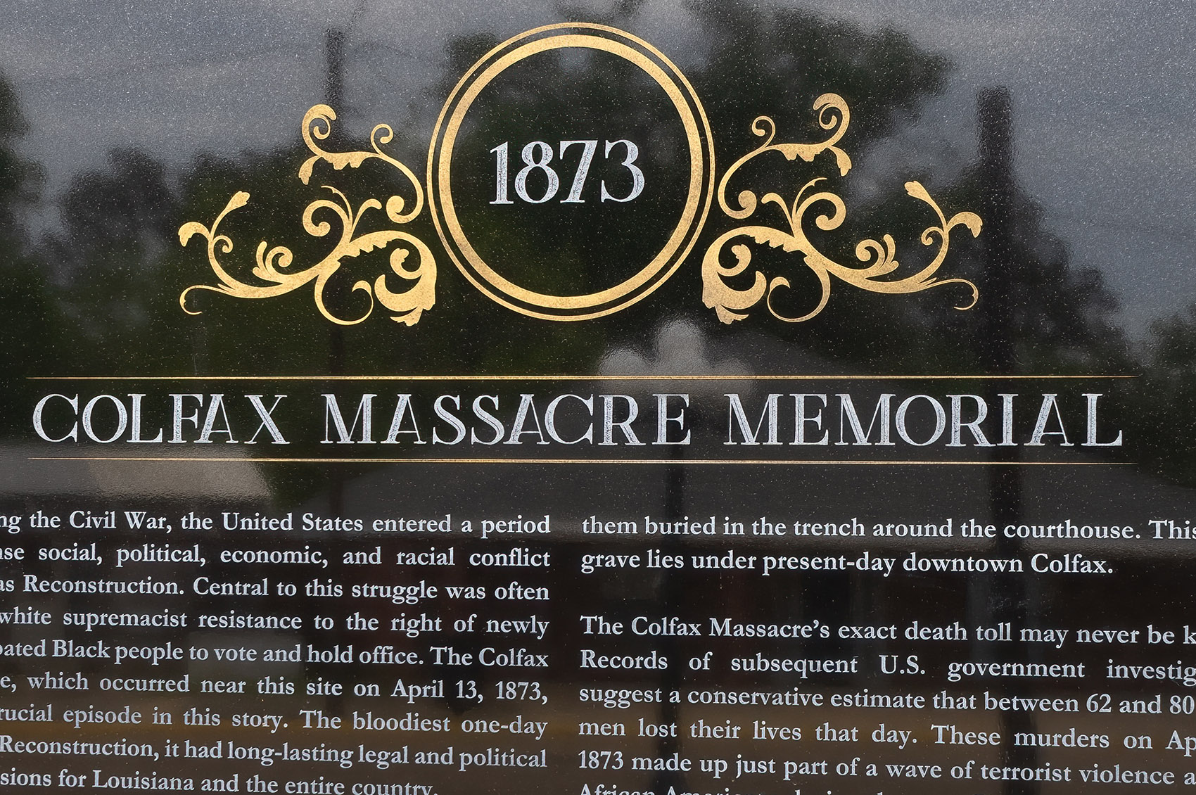 dark granite memorial with date 1873 and colfax massacre