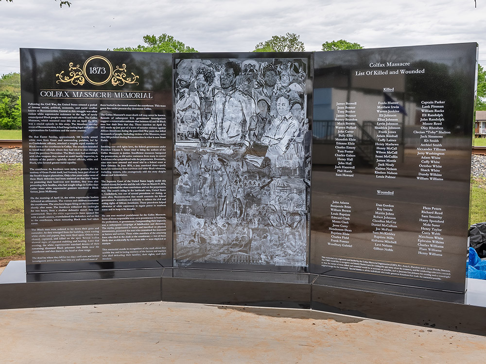brown granite memorial to Colfax Massacre with images and text