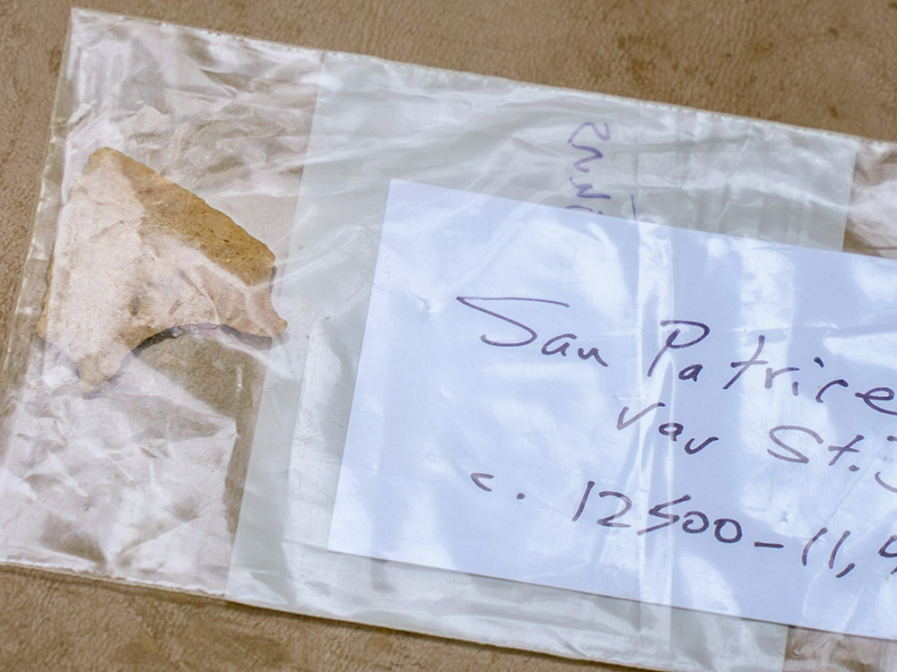 small stone spear point in clear plastic bag with label San Patrice 12,500