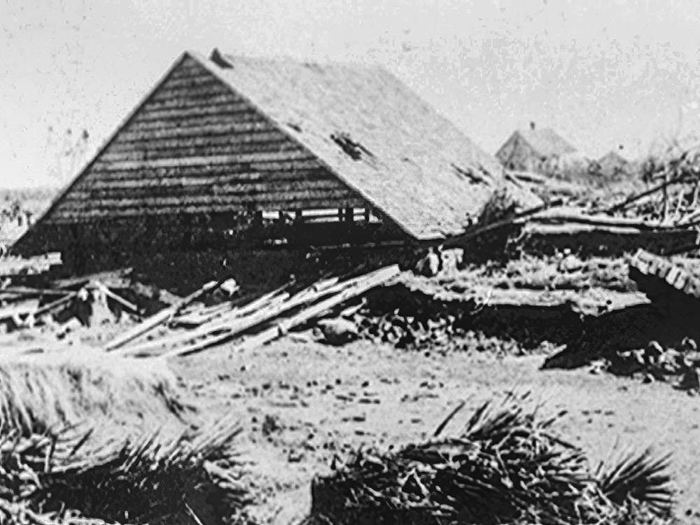 black and white photo of collapsed house from 1893 hurricane at Cheniere Caminada