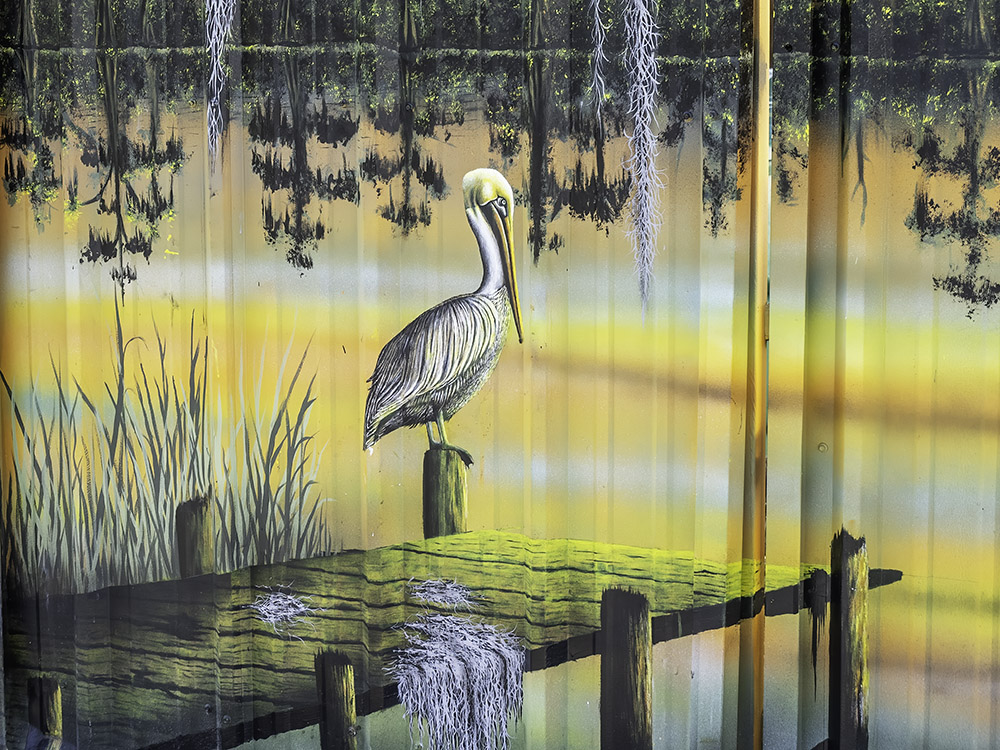 colorful painting of pelican standing on a dock.